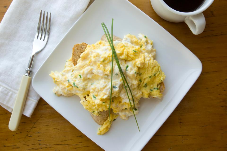  You should only add butter and/or creme fraiche, not milk, to your scrambled eggs