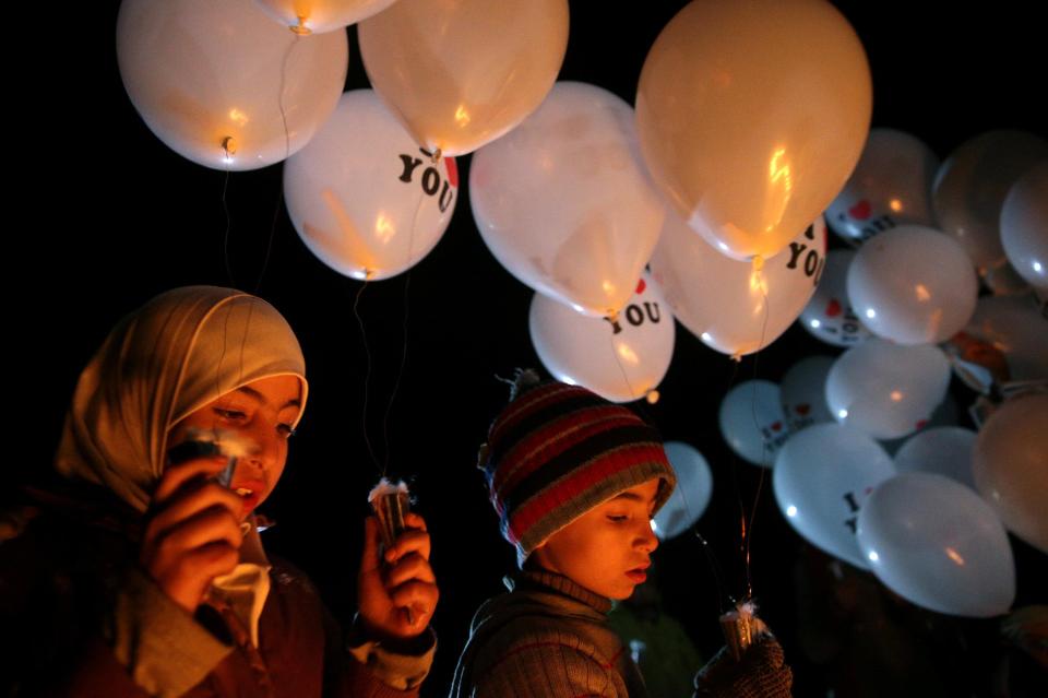  Children carry balloons before releasing them towards Damascus city, on the first day of the truce which was welcomed by the UN