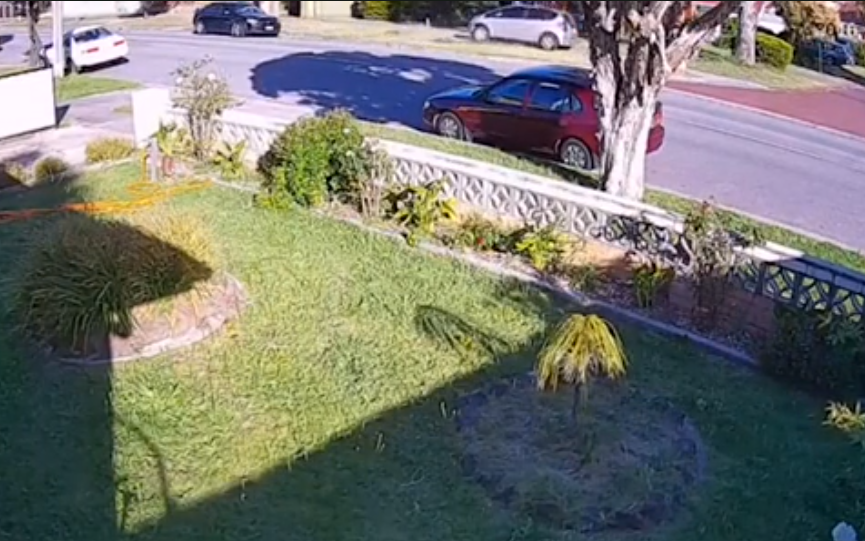 The car is seen driving fast along the pavement