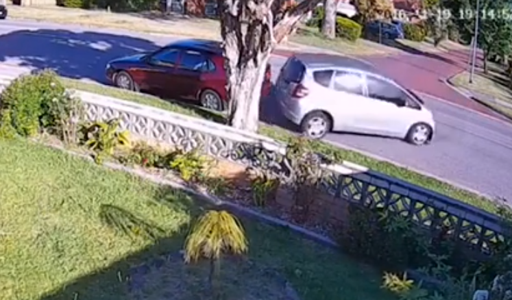 The car spins across the road, flattening a sign