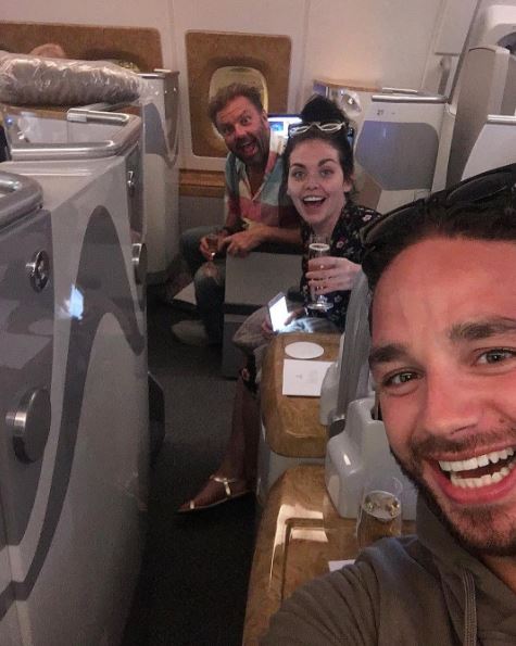 Scarlett Moffatt, Martin Roberts and Adam Thomas raised a glass of bubbly on the plane home