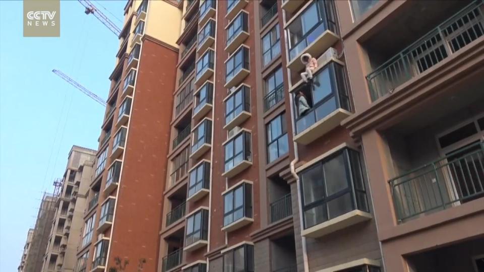  The woman sits with her hood up, refusing to come down