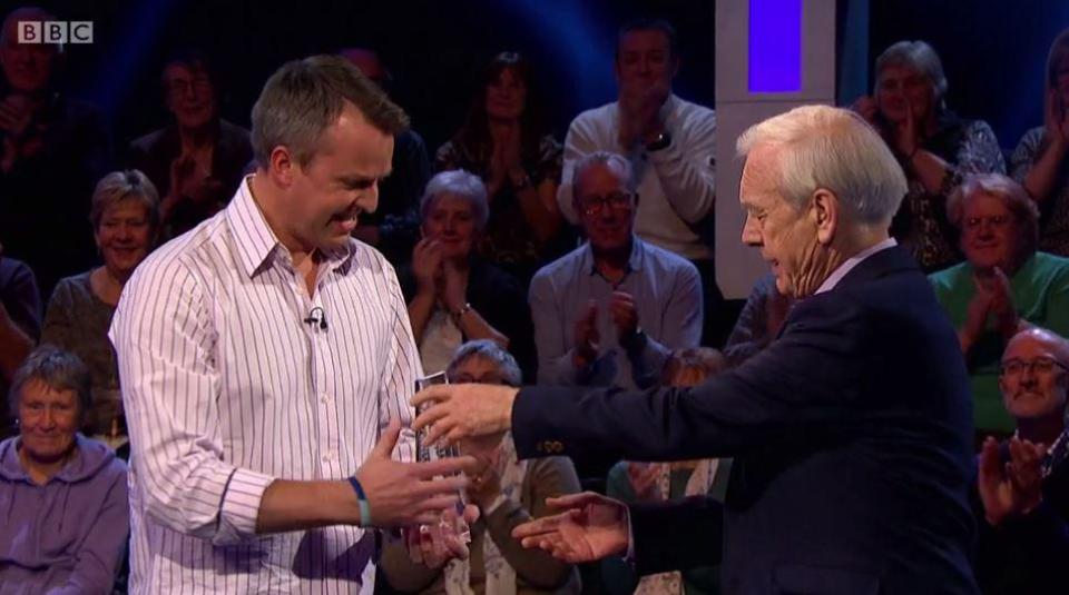 Graeme Swann is presented with his trophy after winning Celebrity Mastermind