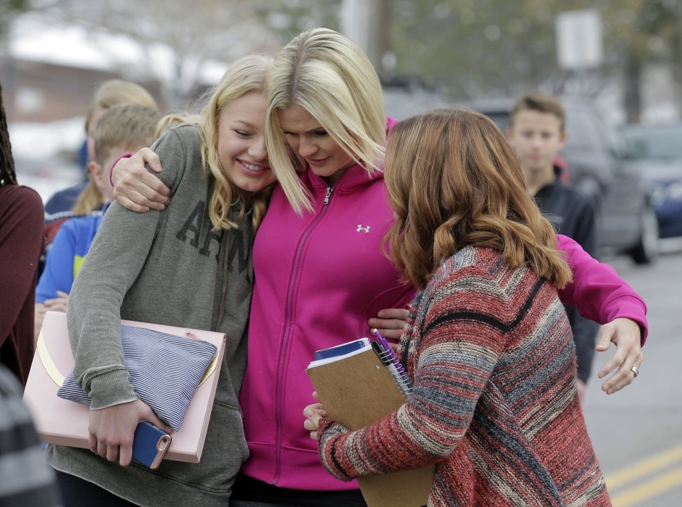  A relieved mother greets her daughter and friend after a teen took a shotgun and handgun to school in Utah and opened fire in a science lesson on Thursday