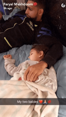 Amir Khan is seen here cuddling with his daughter