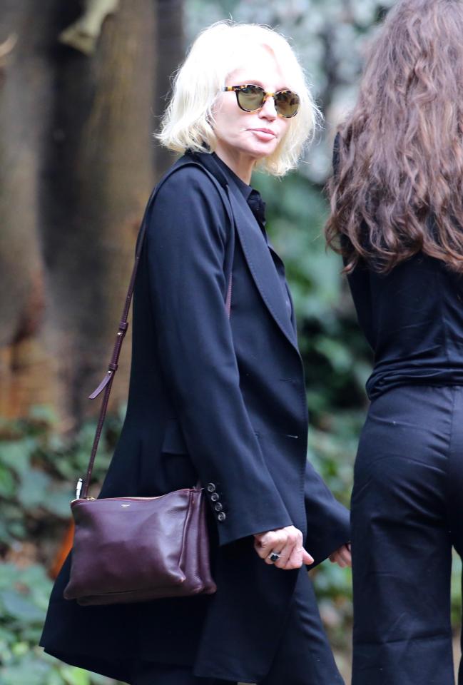  The damp weather did not deter friends and family who wanted to pay their respects - pictured is Ellen Barkin