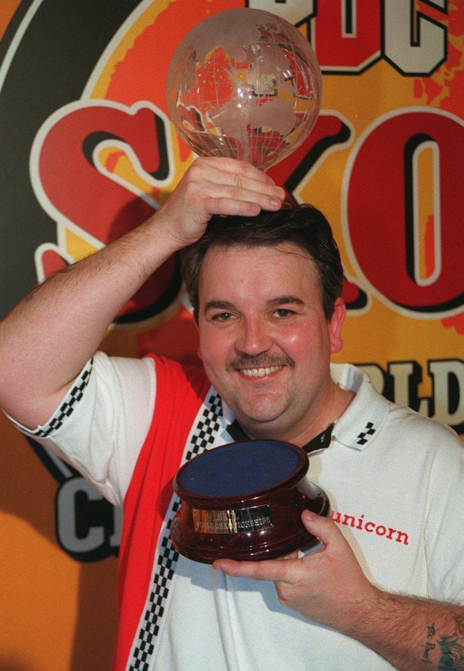  Phil Taylor holds up his sixth PDC World Championship title which he beat Dennis Priestly to at the Circus Tavern