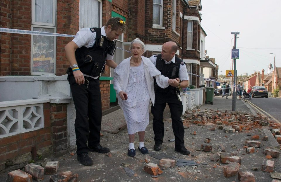  An elderly woman is helped from her home through rubble after a 4.3 earthquake in Folkestone in  2007