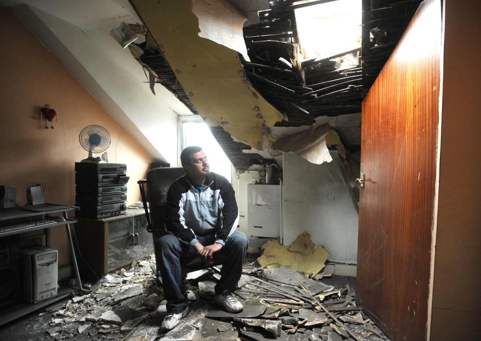  Kleber Afonso sits in his bedroom in Barnsley, South Yorks, after the roof collapsed during a quake measuring 5.2