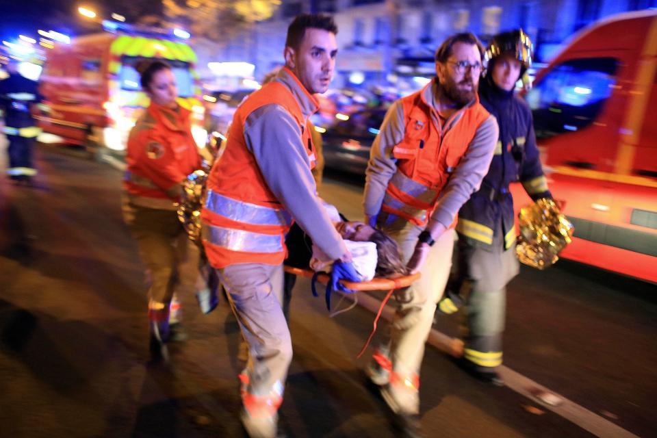  In this November 13, 2015 file photo, a woman is evacuated from the Bataclan concert hall