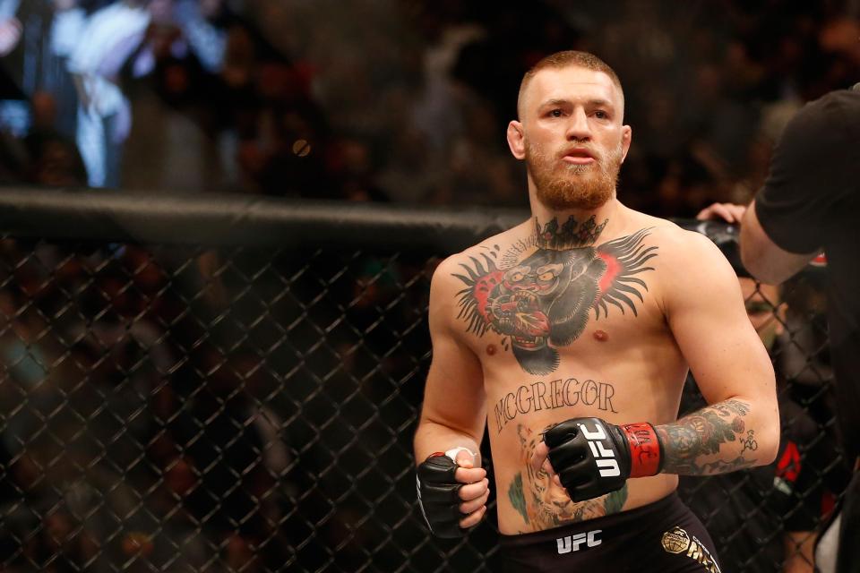  McGregor has a rosebush with a clock on his left forearm, as well as a small stick figure in a boxing pose by his elbow