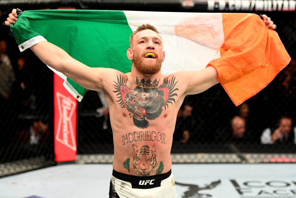  A gorilla wearing a crown and with a heart in its mouth is across McGregor's chest