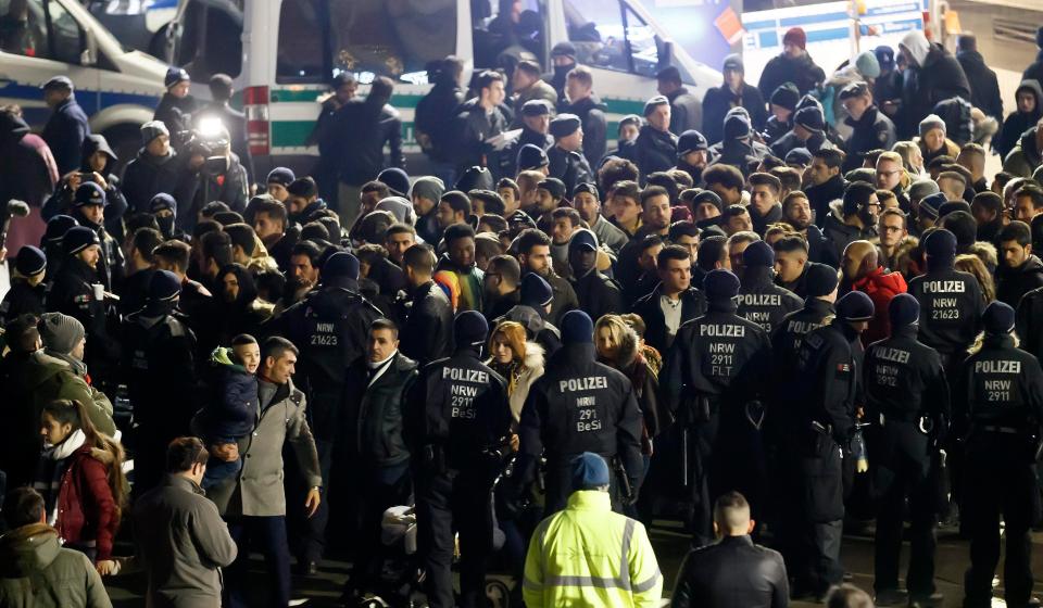  German police officers checking incoming people from North Africa in front of the Central Station in Cologne, Germany, on NYE. Tight security was prompted after hundreds of women were assaulted in the city last year