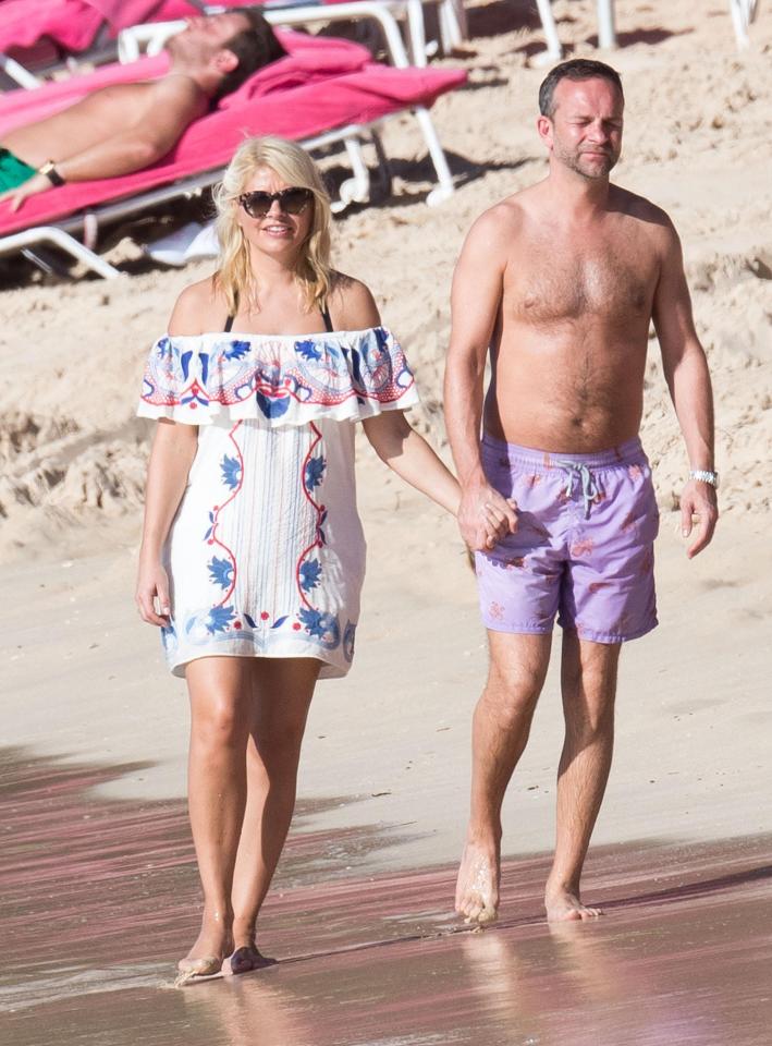  Holly and Dan made their way down the beach holding hands