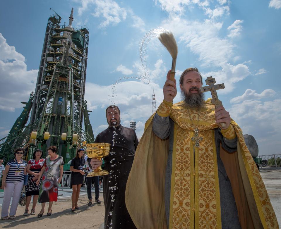  An Orthodox Priest blesses members of the media after he blessed the Soyuz rocket at the Baikonur Cosmodrome Launch pad