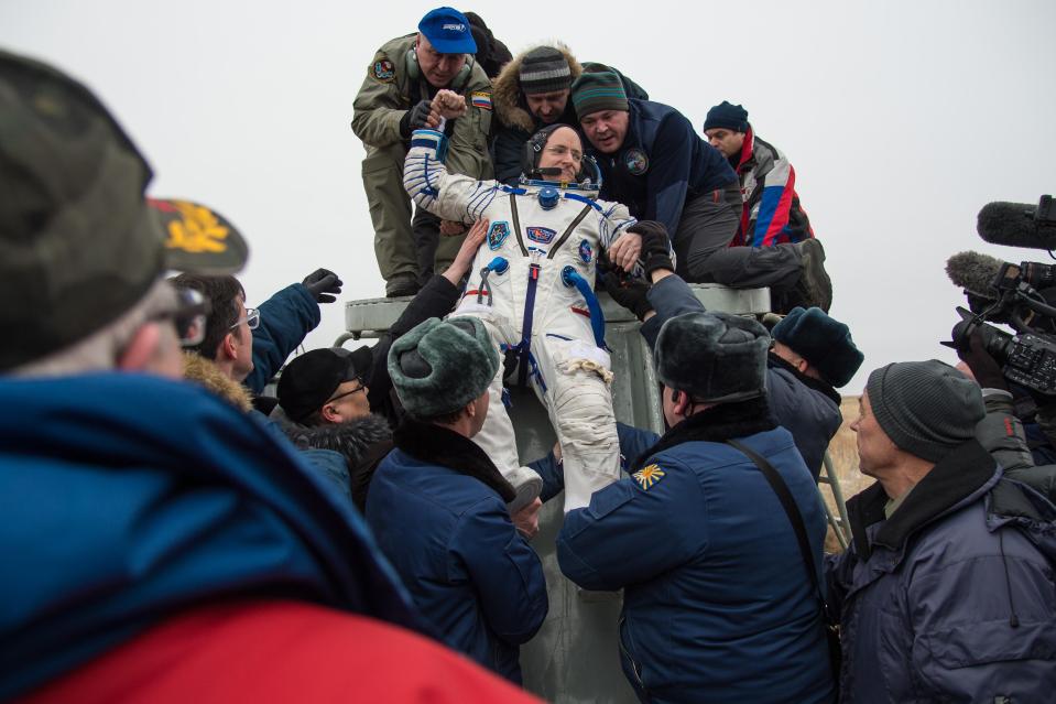  Expedition 46 Commander Scott Kelly of NASA is helped out of the Soyuz TMA-18M spacecraft just minutes after he and Russian cosmonauts Mikhail Kornienko and Sergey Volkov of Roscosmos landed in a remote area near the town of Zhezkazgan, Kazakhstan