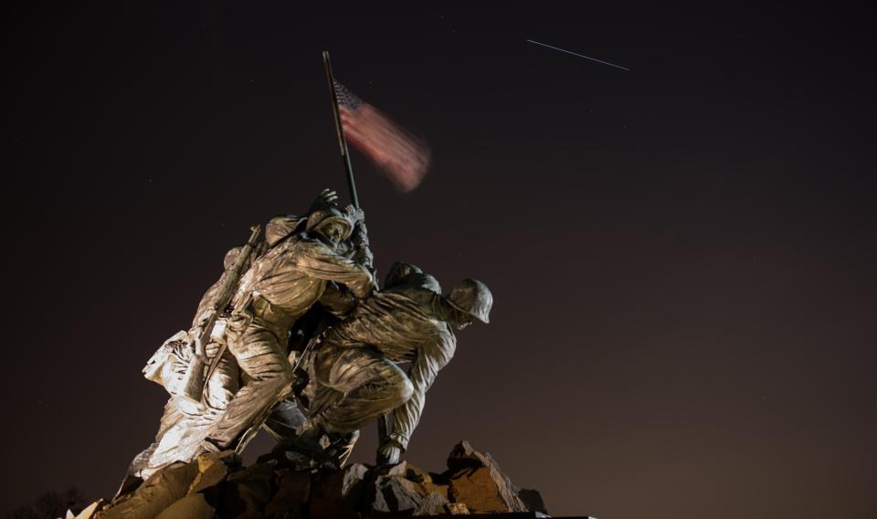  The International Space Station is seen in this 11-second exposure as it passes over the US Marine Corps War Memorial