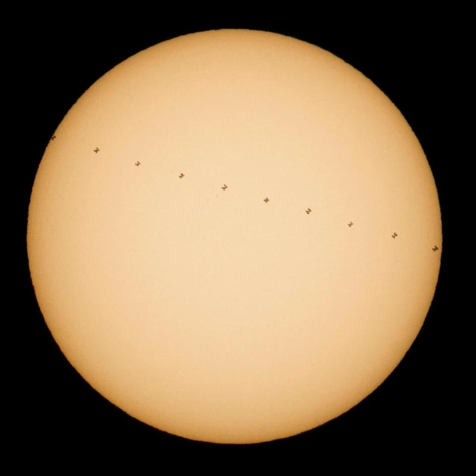  This composite image, made from ten frames, shows the International Space Station, with a crew of six onboard, in silhouette as it transits the sun at roughly five miles per second