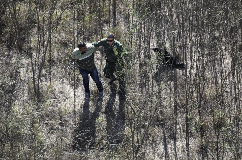  Border agents detain a Mexican man trying to cross the border illegally into Texas