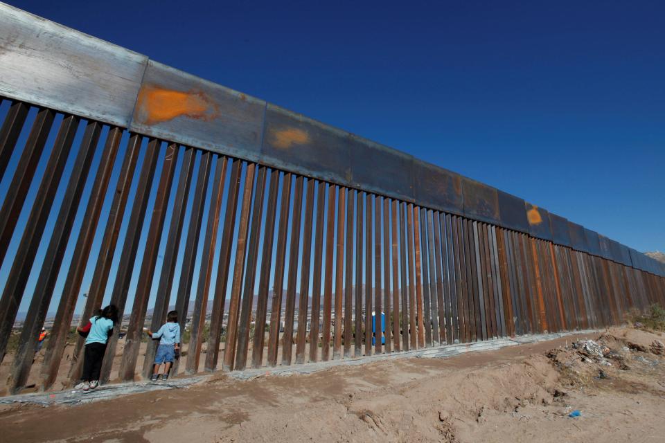  Children play at a newly built section of the U.S.-Mexico border wall at Sunland Park, US