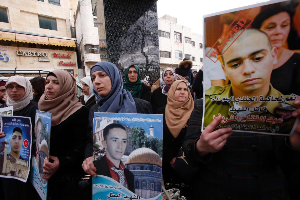  Abdul Fatah al-Sharif's mum Rajaa (centre) carried a poster with an image of her dead son as crowds gathered in the West Bank town of Hebron