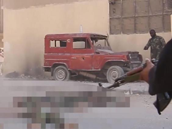  New footage has emerged showing Sarfo, to the right in the background, at an ISIS massacre