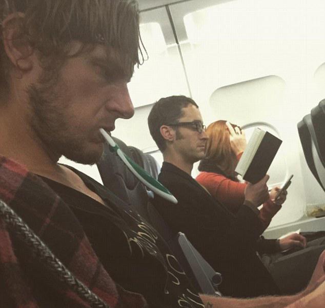  The passenger looks ready for business with his Rambo headband and toothbrush in mouth