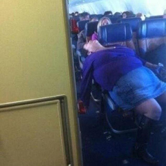  This woman has achieved the impossible - getting comfy on a plane - but has done so across the aisle