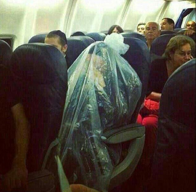  For some unexplained reason, this passenger has covered their entire body in a plastic bag