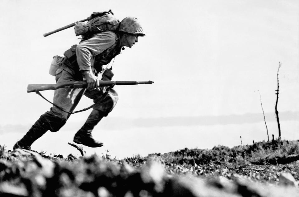 U.S. Marine charges forward through Japanese machine gun fire on Okinawa