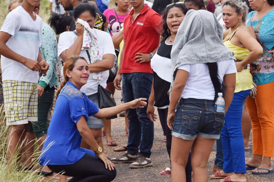  Relatives of inmates wait outside the Monte Cristo prison awaiting news of their loved ones