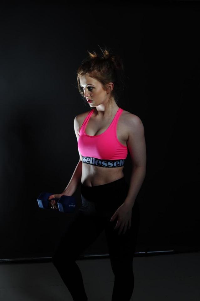  EastEnders star Maisie Smith flashes her abs in her role as fitness guru