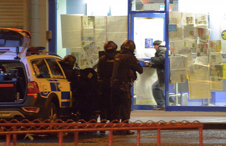  The suspect emerges from the Coral bookies wielding a double-barreled shotgun in shocking pictures emerging tonight