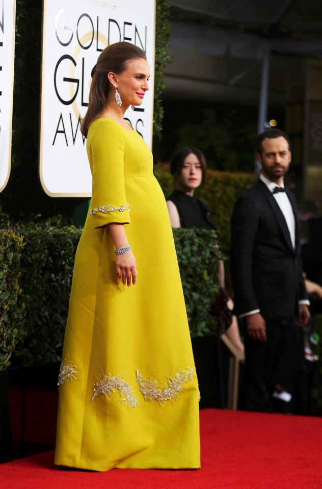  The dress glided over her growing baby bump