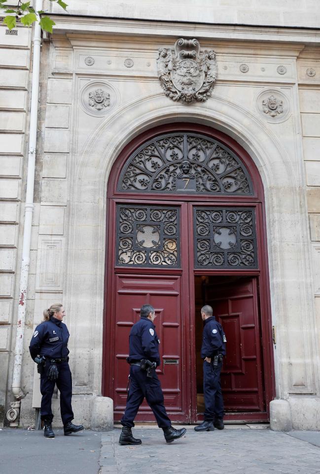  Police officers stand guard outside the hotel where Kim Kardashian was robbed at gunpoint in Paris