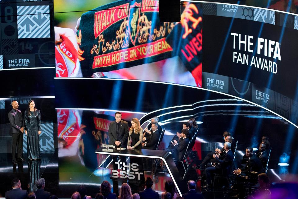  Liverpool and Borussia Dortmund won the joint award for the best fans - here are the two supporters collecting the award