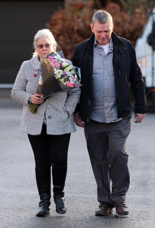  A couple, believed to be Katie's grandparents, were seen laying a floral tribute for the schoolgirl