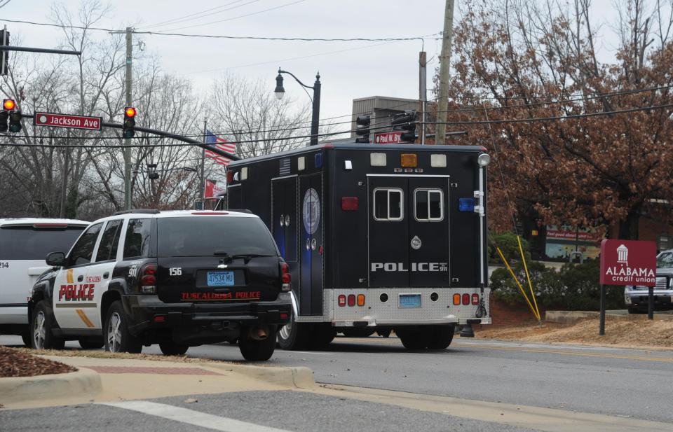  Police cars swarm at the scene of the hostage situation