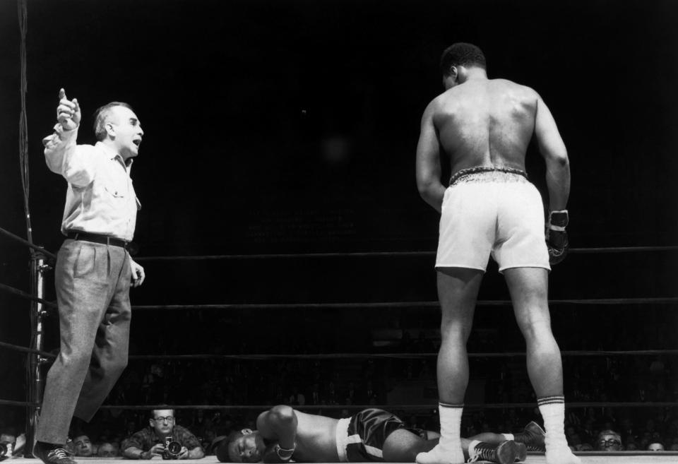 Ali looks at Zora Folley on the floor of their fight on March 23, 1967 in New York - just over a month later he was arrested for draft evasion