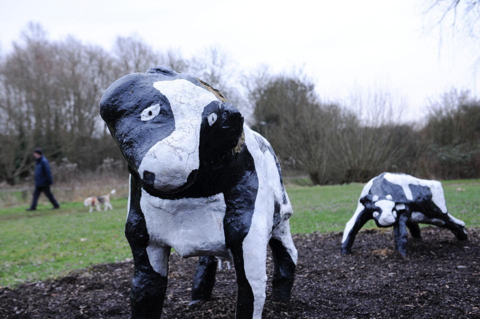  The artwork consists of three black and white cows and three calves, which are approximately half life sized