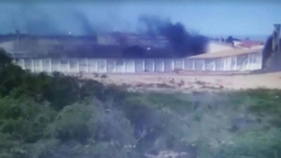  A long distance shot shows the damage caused to the prison by the prisoners