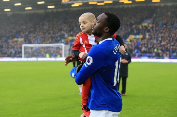 Romelu Lukaku carries out the young Sunderland fan before the game