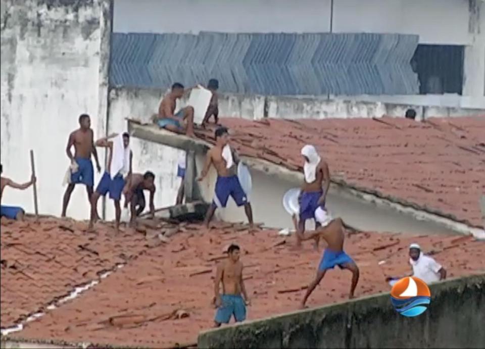  This grab from TV Ponta Negra shows inmates throwing objects from the prison roof