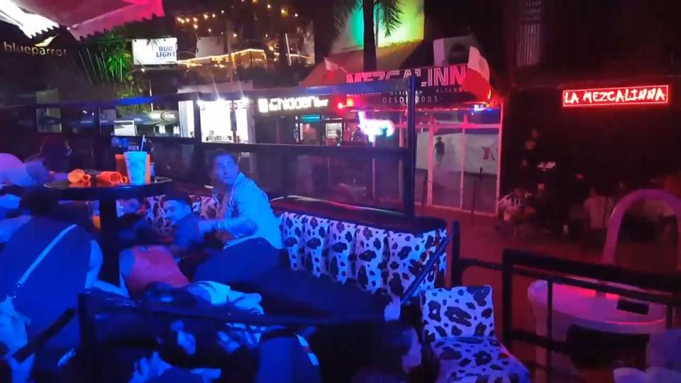  Footage taken inside the Blue Parrot club in Mexico shows tourists hiding behind sofas after shots were fired