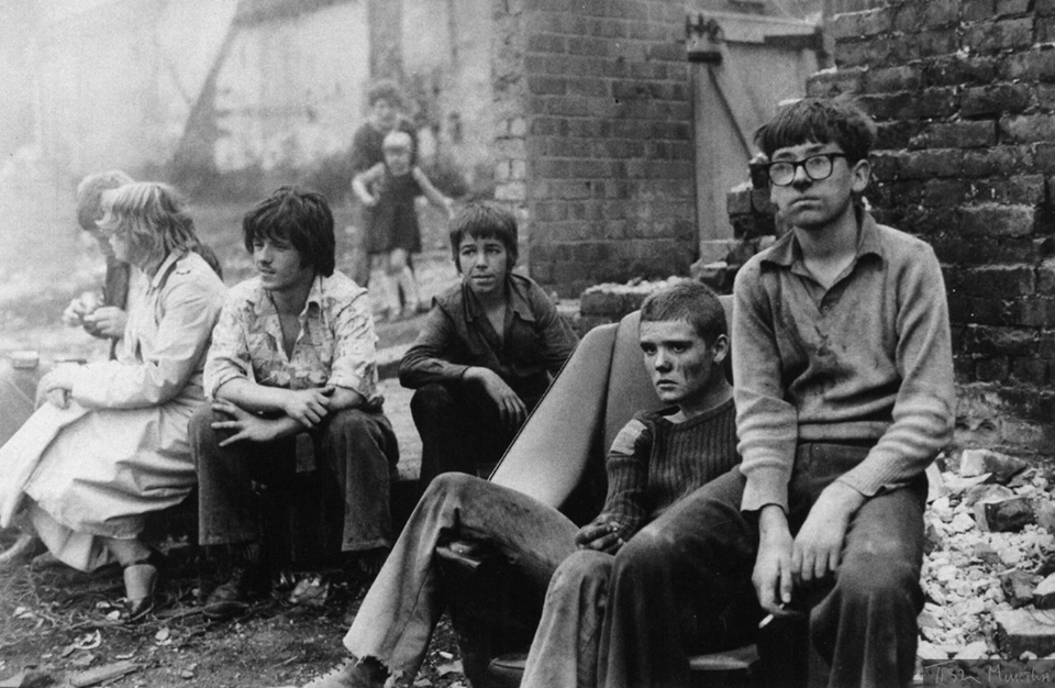  A group of youths sit around in rubble in a derelict part of Newcastle nearly 40 years ago