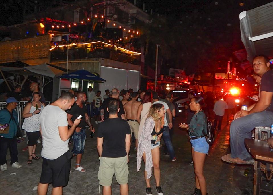  Revellers gathered outside the venue in Mexico where five people were shot and killed