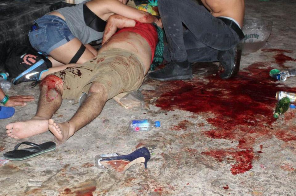  An injuried reveller is pictured lying next to a pool of blood at the festival in Mexico