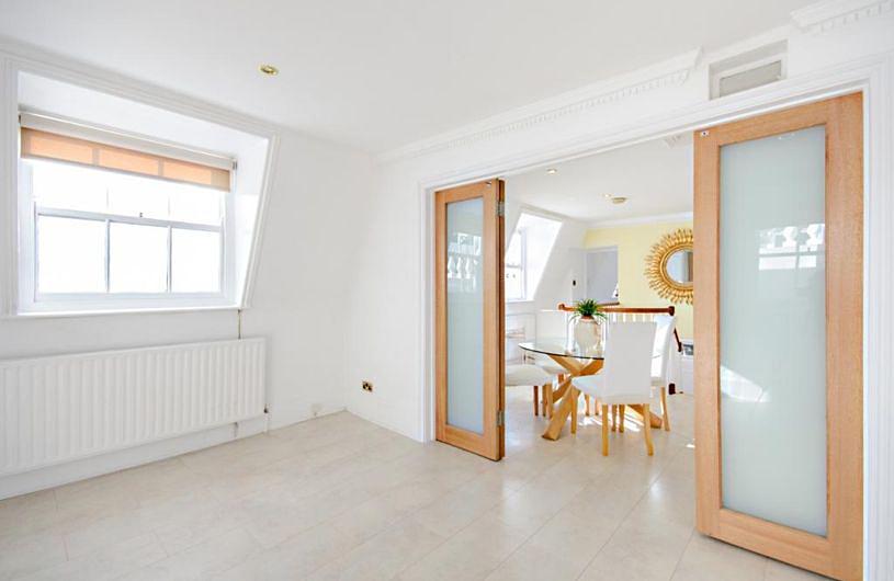 The flat to rent is set on the second floor of the detached Grade-II listed Regency building