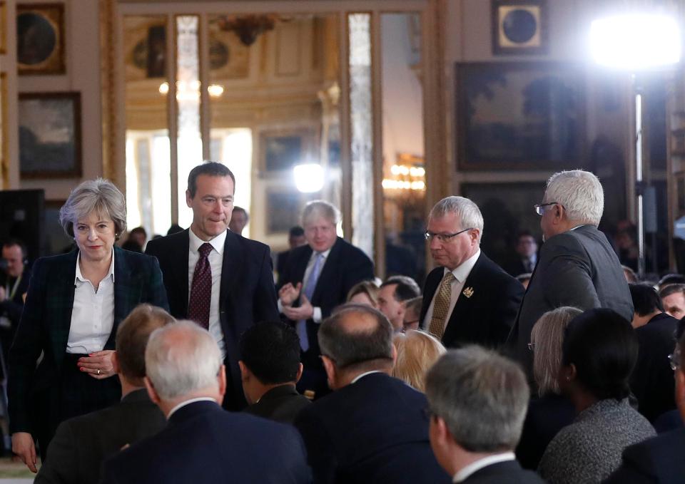  The Foreign Secretary applauds in the background after the PM finishes her speech