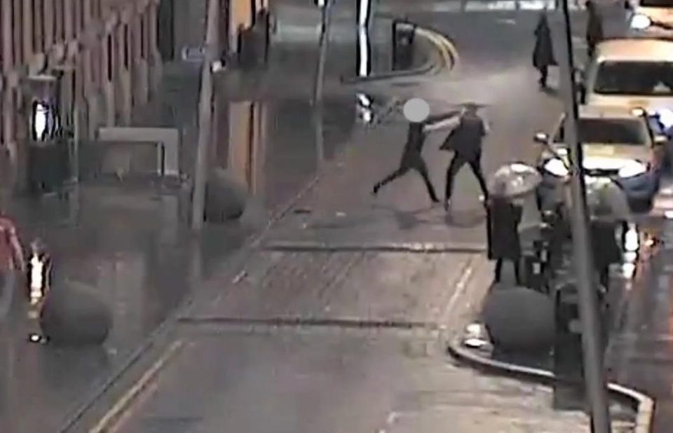 The shocking street brawl was caught on CCTV in Manchester city centre